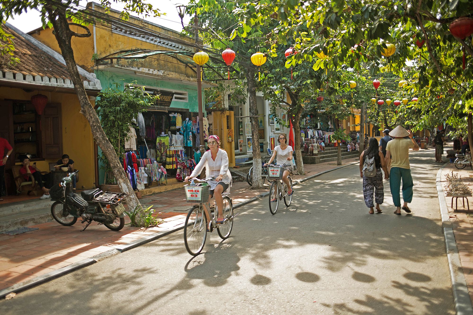 Tourists cycling around Hoi An Ancient Town in July
